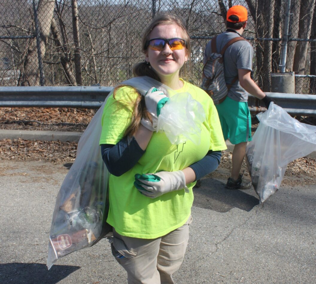 Volunteer collects trash during Musconetcong River Cleanup