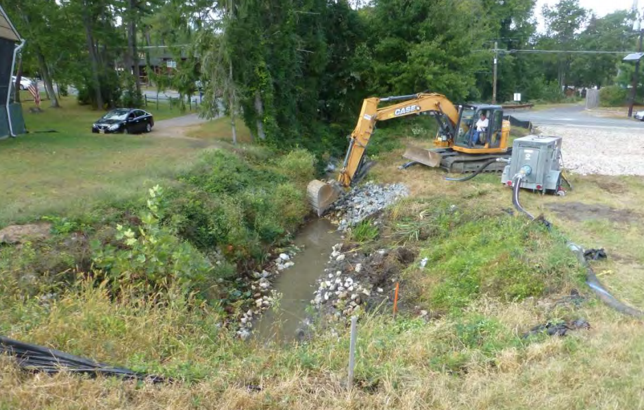 The above photo, taken on October 17, 2019 by Princeton Hydro, shows the riprap being removed from the stream bed prior to pouring the flowable fill concrete mud mat.